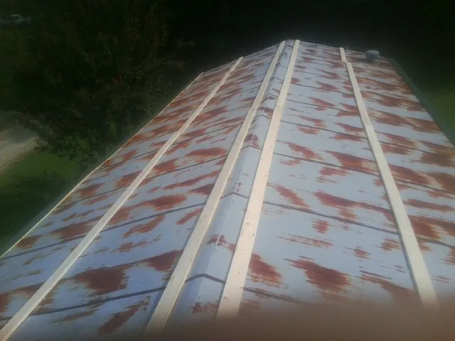 Rusted metal roof panels with new wood purlins before replacement — Storm Damage Roof Repair in Big Clifty by Roofing Brothers