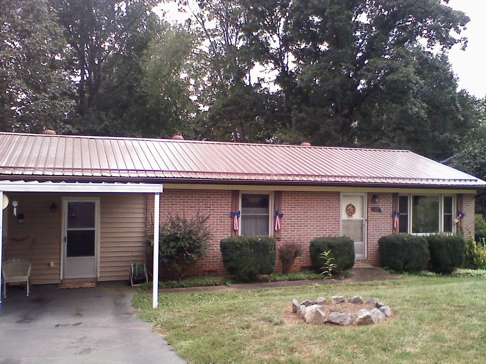 Bronze metal roof and carport on a brick ranch home — Roof Repair work by our crew in Big Clifty