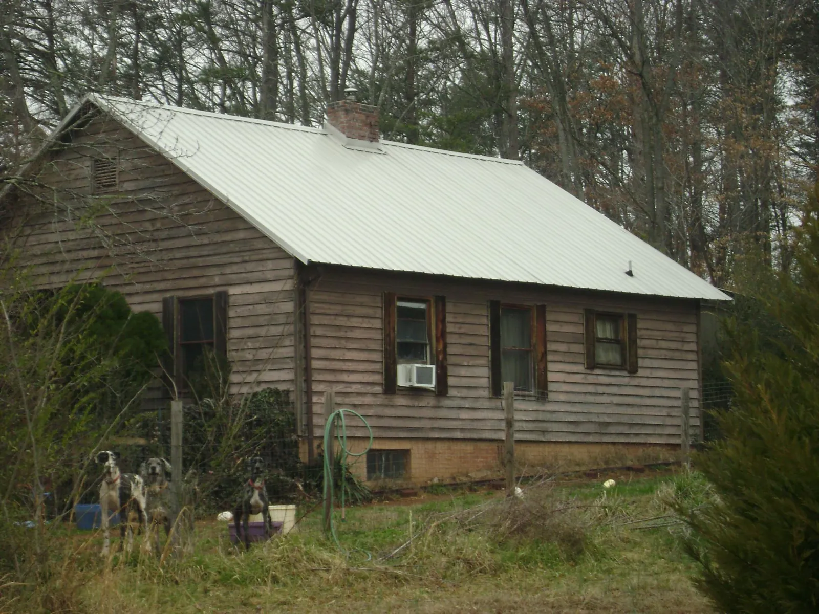 White metal roof on an old wood sided farmhouse, from a Metal Roof Installation job in Big Clifty